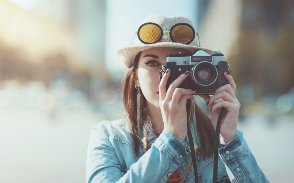 Hipster Girl Taking Picture - iStock_000049851354_Large-min